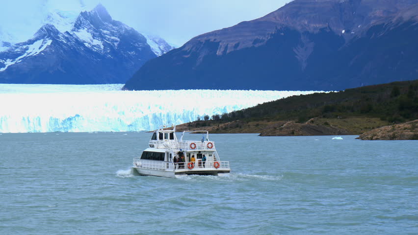 White ship running in front of Perito Moreno Glacier in Argentina