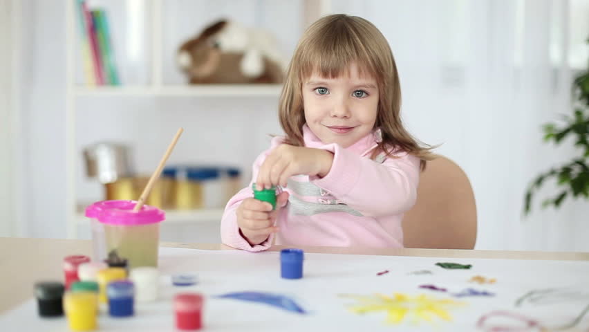 Girl drawing a green paint 