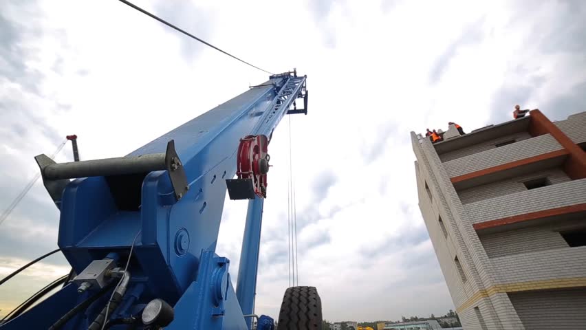 Construction crane at a construction site near the house. truck crane.
