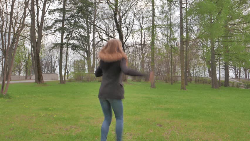 Teen girl dancing in a park. 4K UHD native video.