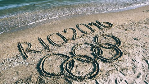 RIO DE JANEIRO, BRAZIL - APRIL 13, 2016: The waves coming to the Olympic rings, an inscription on the beach. Editorial Stock Video