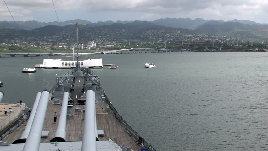 USS Missouri docked at Ford Island in Pearl Harbor, Honolulu, Oahu, Hawaii. Big deck guns aiming over the USS Arizona memorial in a protective stance