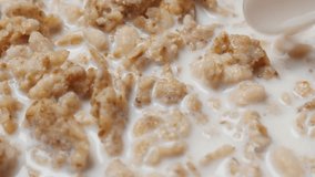 Cornflakes and cereals mixing in the bowl with milk slow-motion 1080p FullHD video - Muesli and milk healthy and tasty breakfast mixing 1920X1080 HD footage