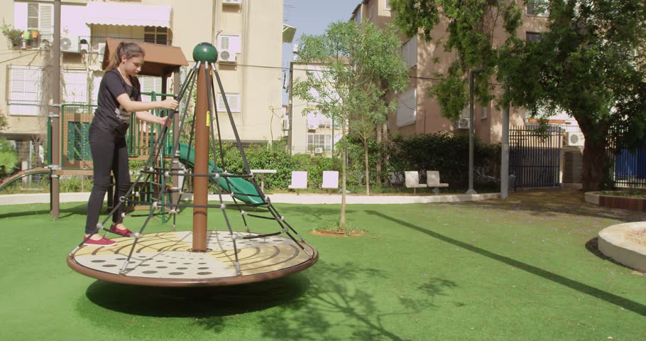 Girl rides on the carousel.