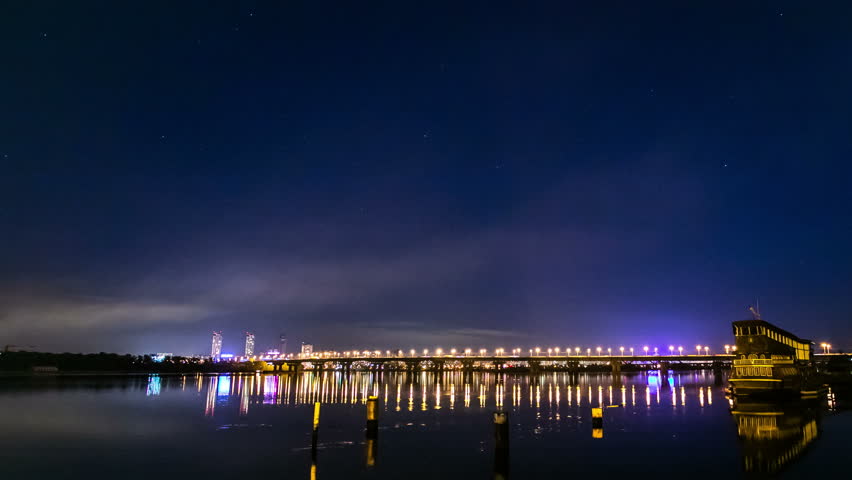Bridge over the river in the night city timelapse outdoors