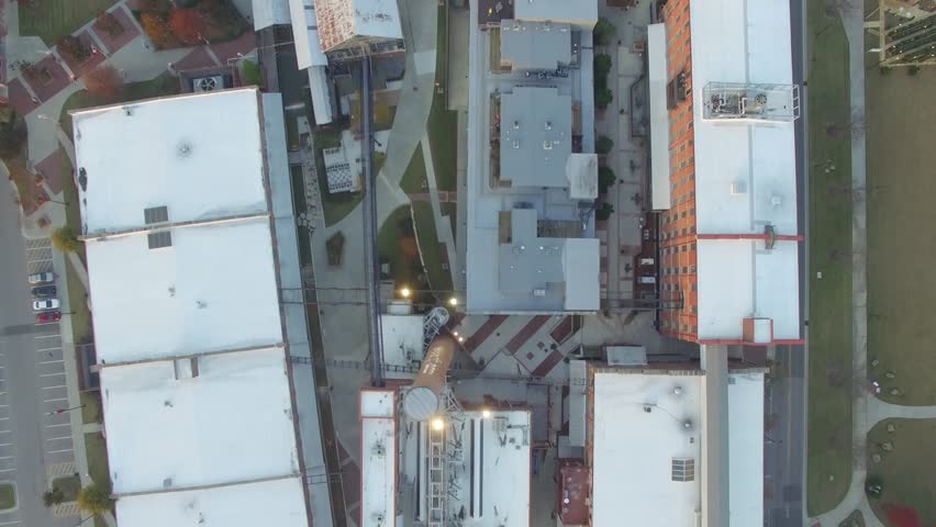 Aerial shot aimed flying south directly down on the top of the buildings of American Tobacco Campus in downtown Durham, North Carolina.