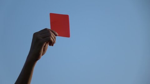 Football referee showing the red card, slow motion.