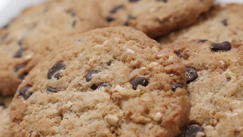 Bunch of chocolate chip cakes close-up tilting 4K 2160p 30fps UltraHD video - Biscuit cookies with pieces of chocolate 4K 3840X2160 UHD slow tilt footage