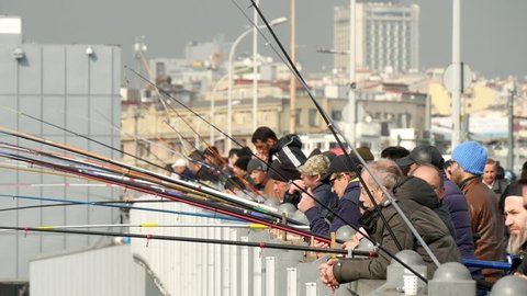 Istanbul, Turkey - March 20, 2016: Fishermen on the Galata Bridge