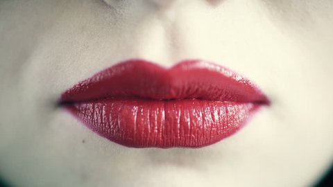Closeup of female lips blowing kiss
