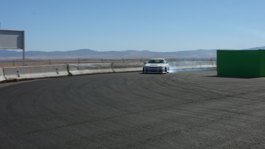 Car Drifting Burning Rubber on Race Track