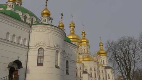 Shining Church Cupolas Behind a Tree, Church Complex, Green Roofs, White Walls and Golden Cupolas of Holy Dormition Kiev-Pechersk Lavra, Dormition Cathedral, Church of a Dormition of Mary Jesus'