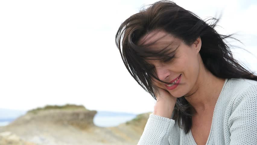 Attractive middle-aged woman by the sea