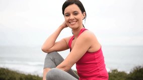 Woman in fitness outfit relaxing after exercising