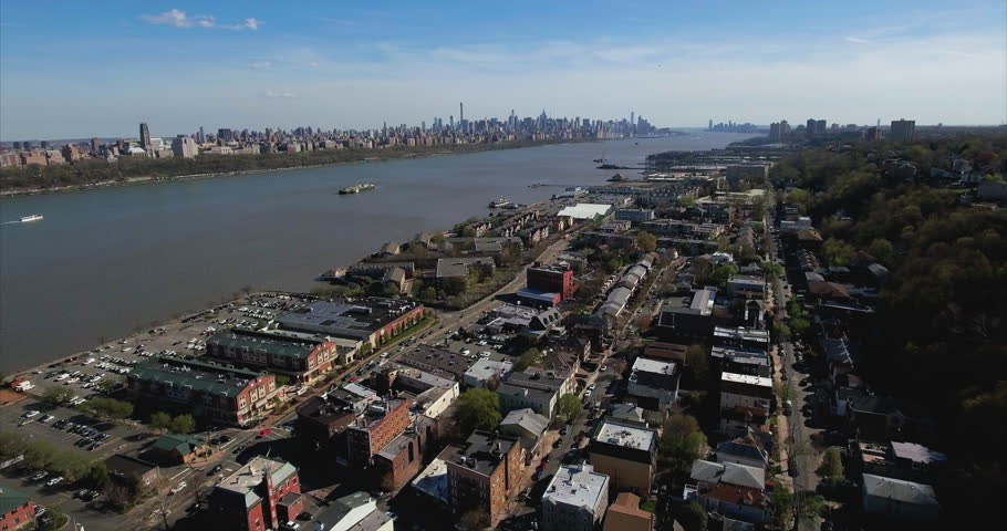 River Road shops and riverside condos in Edgewater with the Manhattan skyline far downriver.