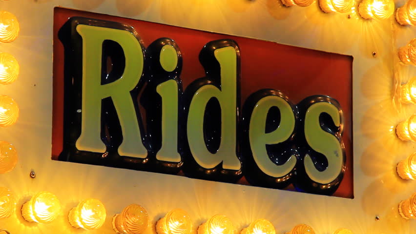 Rides sign surrounded by lights at the CNE midway in Toronto, Canada.