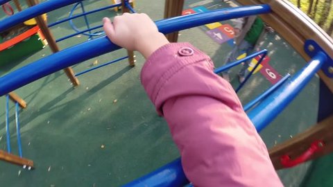 Girl climbing on ladder on children playground, First Person View