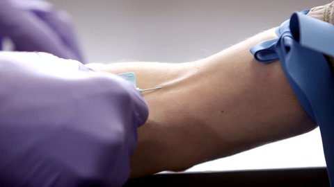 Phlebotomist Draws Blood from a Patient Closeup