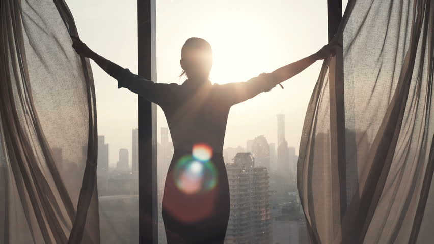 Young businesswoman unveil curtain and looking out of window
 | Shutterstock HD Video #16318348