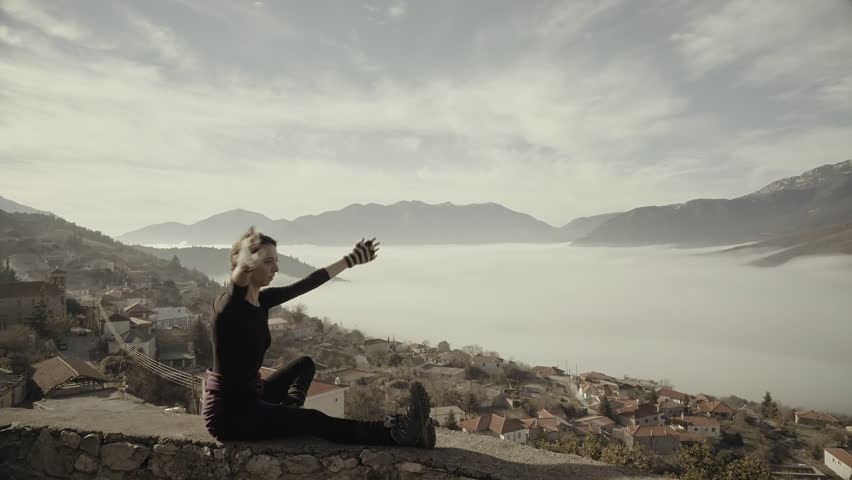 Woman exercizing yoga in Greek nature,mountain,village,winter time,morning.A woman doing yoga exercizes outside in nature in the beautiful Greek mountain village of Goura
