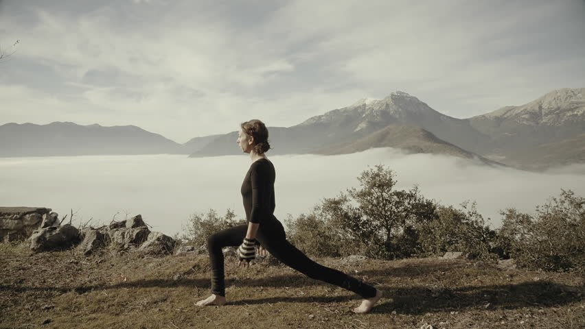 Woman exercizing yoga in Greek nature,mountain,village,winter time,morning.A woman doing yoga exercizes outside in nature in the beautiful Greek mountain village of Goura