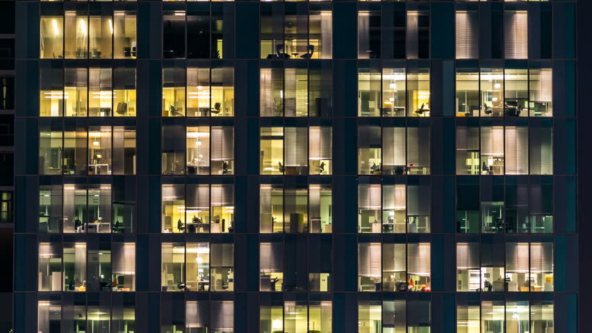 window of the multi-storey building of glass and steel lighting and people within timelapse Royalty-Free Stock Footage #16330531