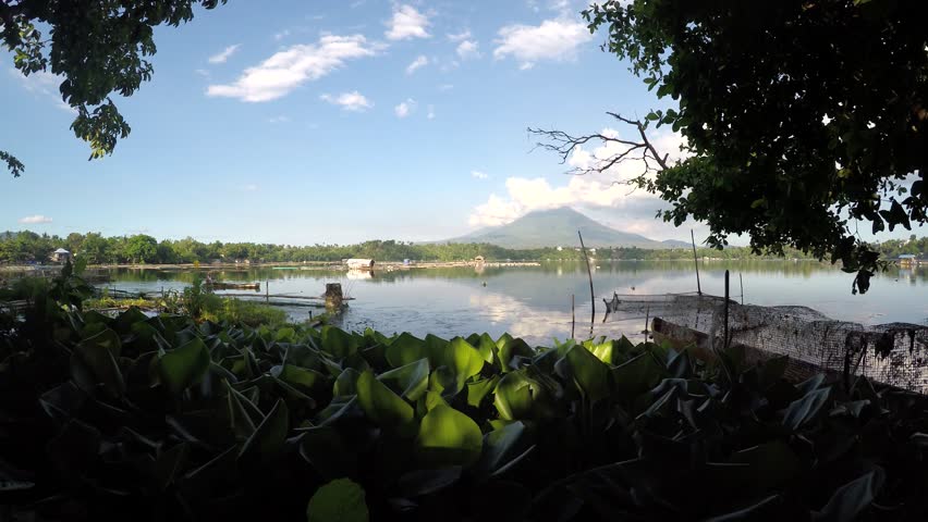 SAMPALOC LAKE, SAN PABLO CITY, LAGUNA, PHILIPPINES - APRIL 29, 2016: a lake fishfolk maneuvers his boat on lake