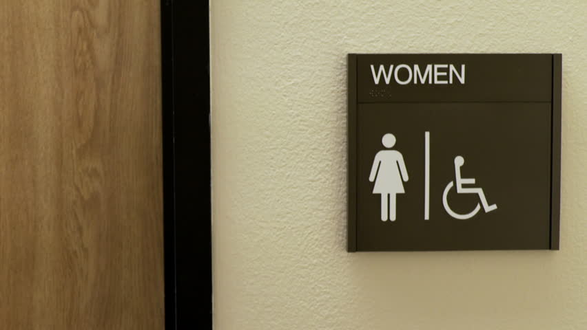 woman walking into a womans restroom in an office Royalty-Free Stock Footage #16342201