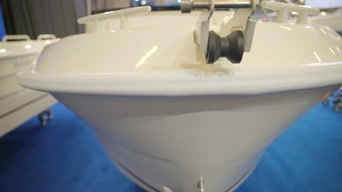 The front view of the white small boat one of the displays inside the showroom