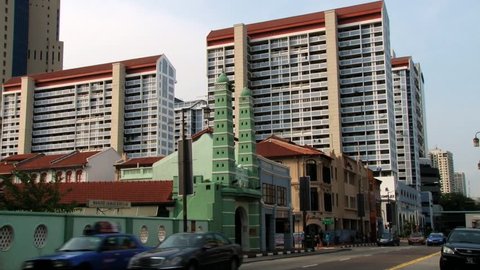 SINGAPORE, SINGAPORE - MARCH 30, 2014: Exterior of the Masjid Jamae mosque in Chinatown district with modern residential buildings at the background in Singapore, Singapore.