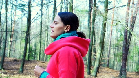Woman jogging in woods, steadycam shot, slow motion shot at 240fps
