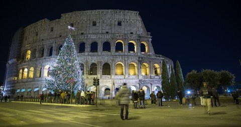Rome, Italy - illuminated Colosseo at night with christmas tree - Timelapse without movement
