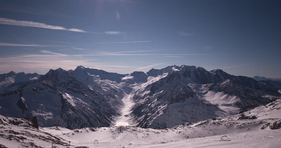 Zillertal, Tirol, Austria - snowy mountains and valley with lift in the alps at a sunny day with blue sky and clouds - Timelapse with movement - March 2014
