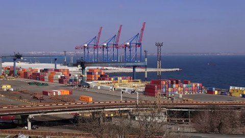 Odessa, Ukraine - 08 March 2015: Harbour terminal industrial sea port with loading cranes and containers platforms machines