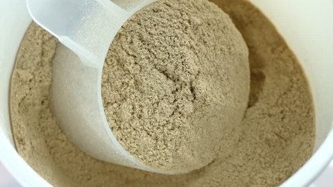 Scoop of chocolate meal replacement shake powder rotating