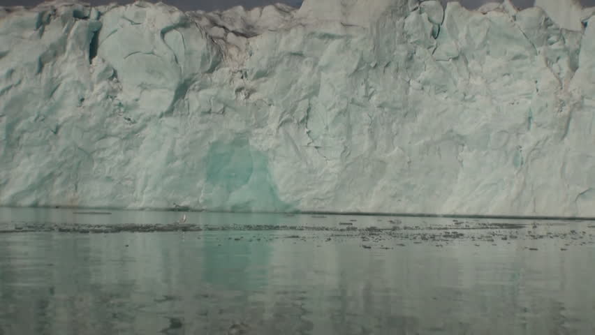 Sea mountains and large icebergs reflecting in the water.  Fantastic wonderful amazing video grennlandii nature iceland. Lovely shooting the life of nature, seaside and mountains.