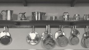 Vintage-style monochrome clip of some old kitchen utensils.  The clip was edited to give the old film effect.