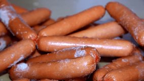 closeup of many fresh frozen sausages for hot-dogs