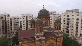 Aerial view of a church in the middle of the city next to residential buildings