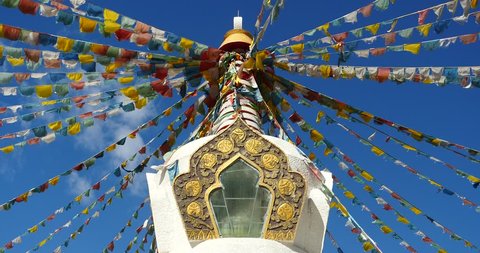 4k buddhist white stupa & flying prayer flags with blue sky background,shangrila yunnan,china. gh2_10490_4k