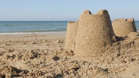 Vacation on summer by the sea with sand towers background 4K 3840X2160 UltraHD footage - Sand art castles by the ocean beach 4K 2160p 30fps UHD video