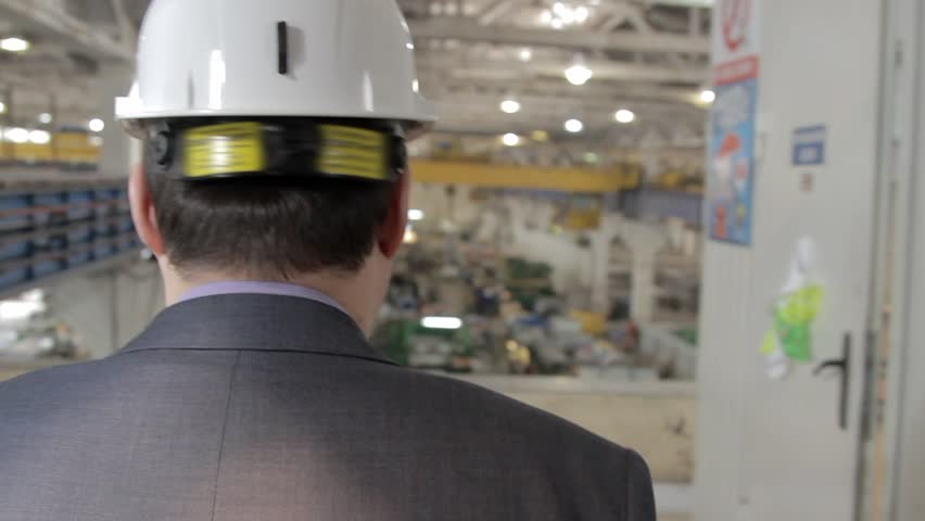 engineer goes and watching on production back view Royalty-Free Stock Footage #16412413
