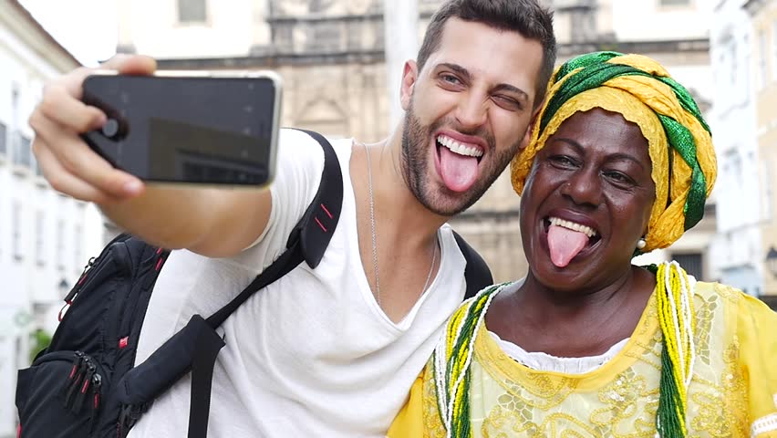 Tourist taking a selfie with a Baiana in the old colonial district of Salvador, Brazil Royalty-Free Stock Footage #16414714