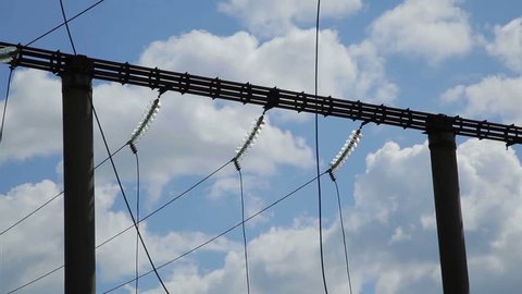 High voltage towers with sky background. High-voltage power line. A high voltage power pylons against blue sky and sun rays - Stock Video