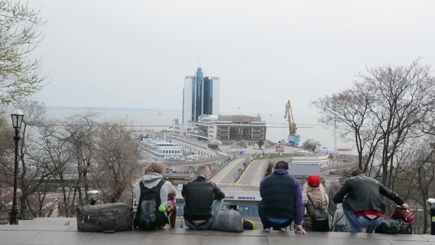 Marine Station in Odessa. Ukraine. Tourists sit on the stairs and look at the sea