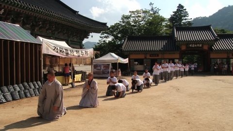 HAEINSA, KOREA - AUGUST 12, 2013: Unidentified pilgrims approach Haeinsa Buddhist temple in Haeinsa, Korea.