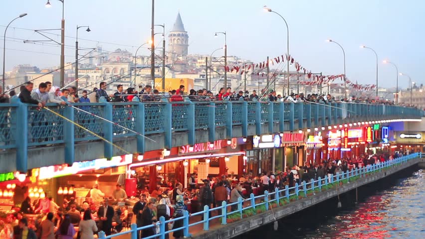 ISTANBUL - NOVEMBER 20: Crowd of people enjoy themselves on Galata Bridge on