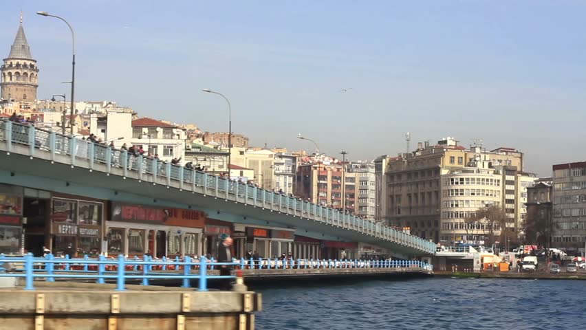 ISTANBUL - MARCH 16: Passenger boat passes under Galata Bridge on March 16, 2011