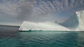 Big Iicebergs floating in sea around  Greenland in icefjords. Fantastic wonderful amazing video grenland nature iceland. Lovely shooting the life of nature, seaside and mountains. Global warming.