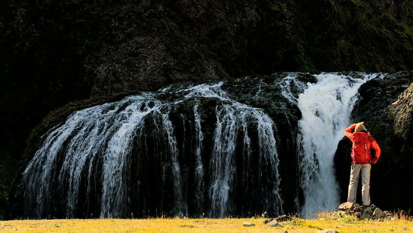 Lone Female on Hiking Expedition by Waterfall
